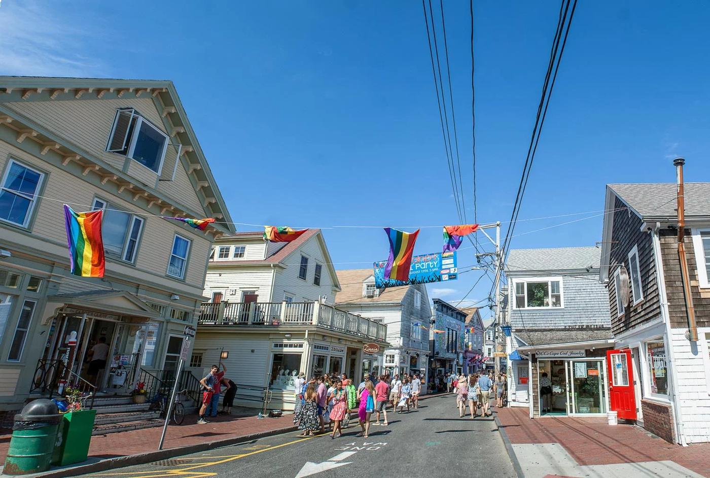 Commercial Street in Provincetown, hung with international flags, crowded with people